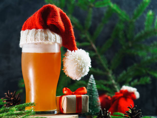 Christmas ale glass in Santa's festive hat. Christmas party Christmas ale glass in Santa's festive hat. Christmas party india pale ale photos stock pictures, royalty-free photos & images