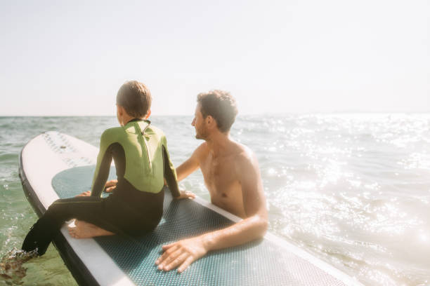 istock Cute little surfer and his dad 1189135766