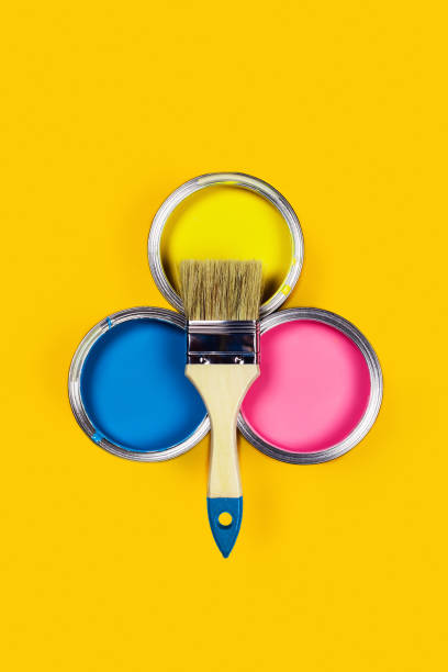 istock Colored background with paint jars and brush. 1189136780