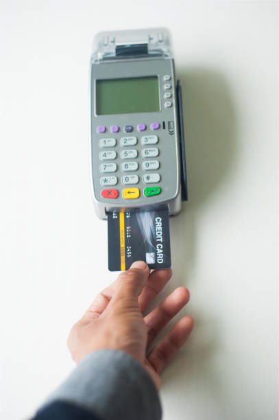 istock Credit cards and payment using a card swipe machine. 1189137116