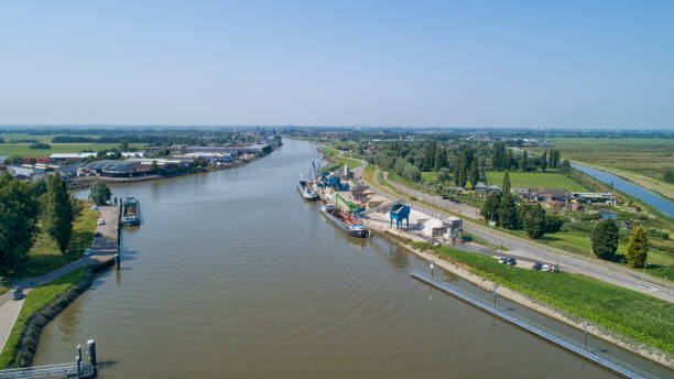 istock Loading barge with sand and rubble on a small berth. Freight transport logistics 1189140009