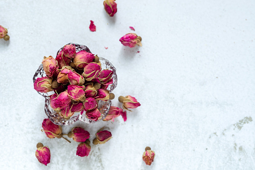 Dried White and pink orchid flowers on a gray textured background, space for a text, flat lay, view from above