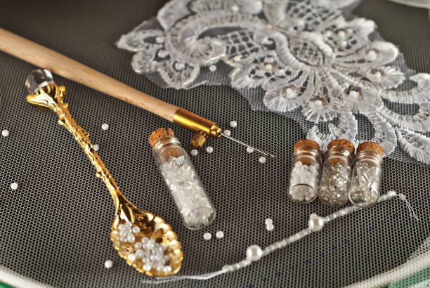 istock White and gray beads in glass jars on black background. Beads in a transparent container with a wooden cork. Crochet knitting with hook and needle. Beadwork on a wedding dress. 1189141137