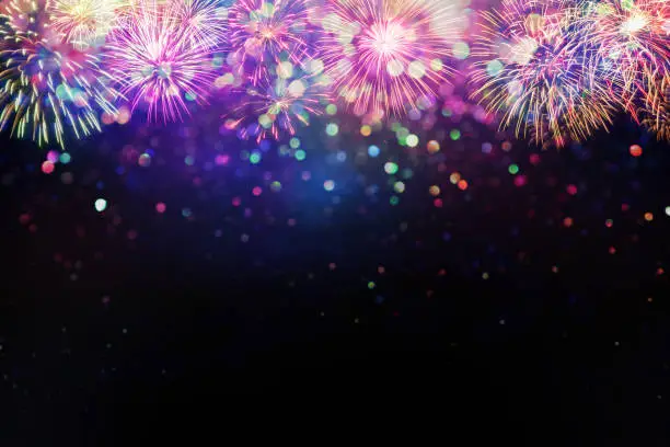 Photo of beautiful fireworks and glitter bokeh lighting effect Colorfull Blurred abstract background for anniversary, new year eve or Christmas