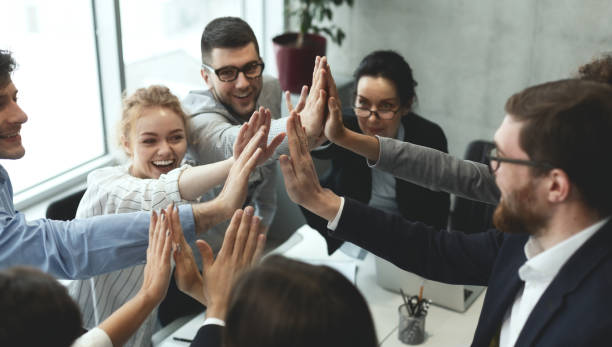 istock Motivated business team giving group high five 1189143751