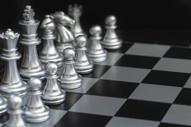 istock Closeup silver chess on the chess board detail blur art 1189143825