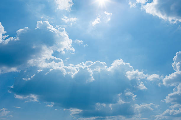 istock blue sky and bright clouds with the sun shining 1189143839