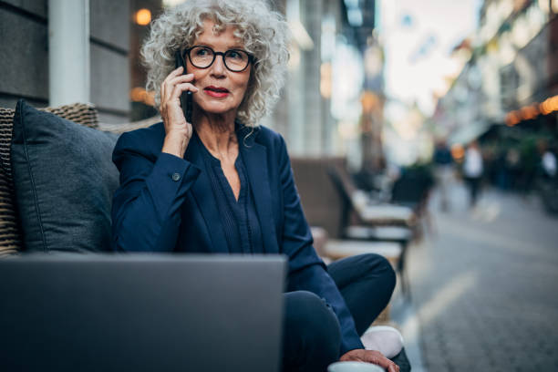 istock Senior lady talking on mobile in cafe 1189143905