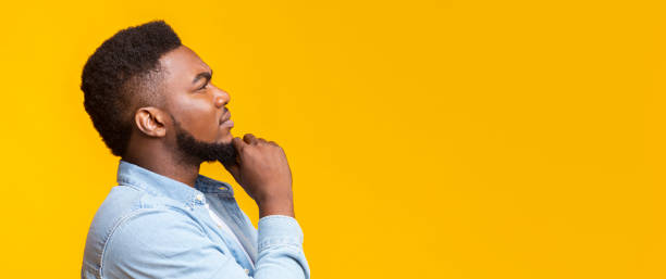 istock Thoughtful african man touching his beard and looking at copy space 1189143926