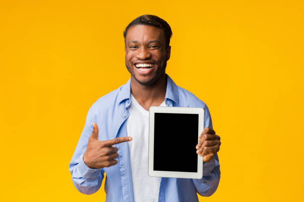 istock Man Pointing Finger At Tablet Screen Standing, Studio Shot, Mockup 1189144813