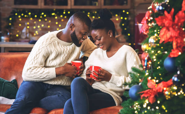 istock Black couple celebrating Christmas together, reading coffee grounds for fun 1189145217