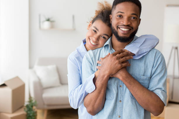 istock Black Couple Hugging Standing In New Apartment 1189146245