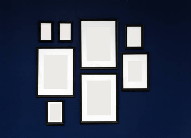 istock composition of 8 black photo frames on a blue wall background. empty white space for photos. mock up poster. 1189146287