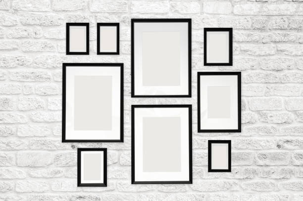 istock composition of 9 black photo frames on a white brick wall background. empty white space for photos. mock up poster. 1189146303