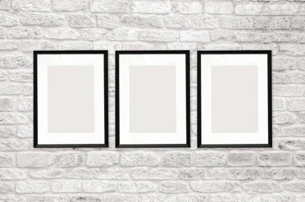 istock composition of 3 black photo frames on a white brick wall background. empty white space for photos. mock up poster. 1189146313