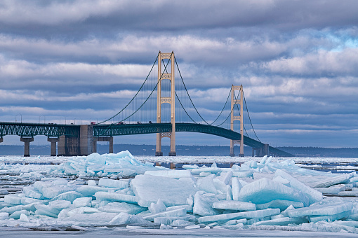 Winter landscape of blue ice shards and the Mackinac Bridge, Straits of Mackinac, Lake Michigan, Michigan, USA