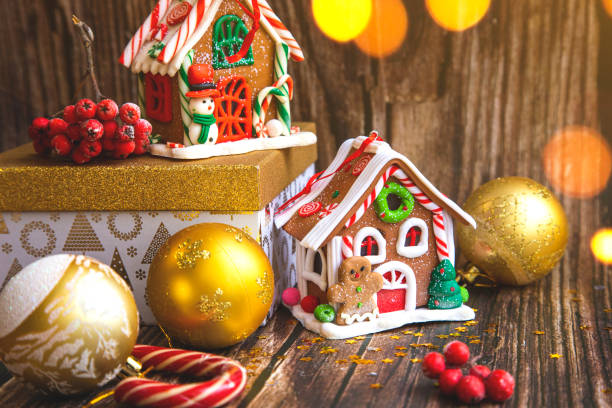 istock Gingerbread candy house, Christmas accessories and decorations on wood background. 1189149788