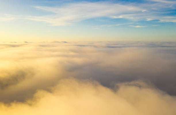 istock Flying over the evening clouds with the late sun. 1189154119