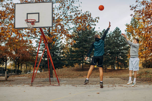 istock Two friends play basketball 1189154226