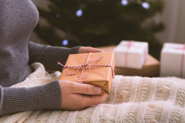 istock Unrecognizable woman holding Christmas gift in hands 1189156077
