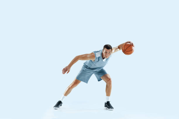istock Young caucasian basketball player against white studio background 1189156687