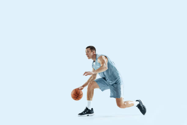 istock Young caucasian basketball player against white studio background 1189156703