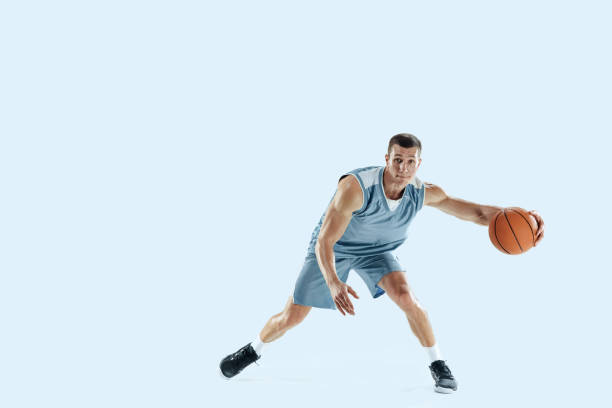 istock Young caucasian basketball player against white studio background 1189156710