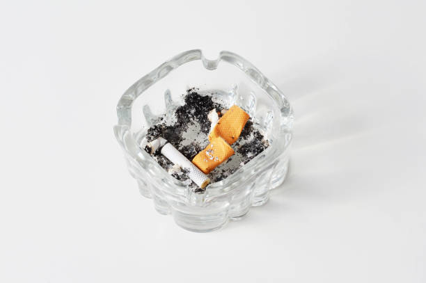 istock Ashtray with Cigarette Butts on White Background 1189157009