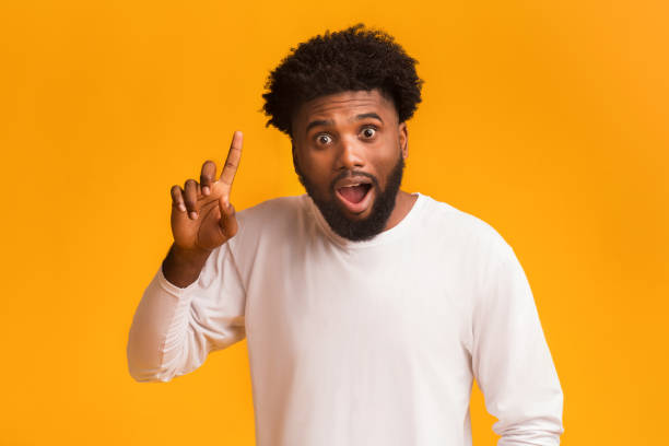 istock African american emotional man having idea, pointing finger up 1189157515