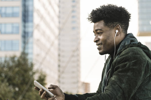 istock cool young black man with smart phone in the city 1189157722