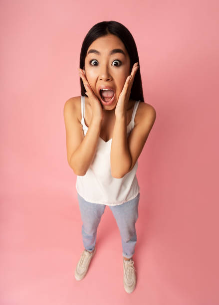 istock Really? Shocked girl shouting and holding hands on cheeks 1189158422