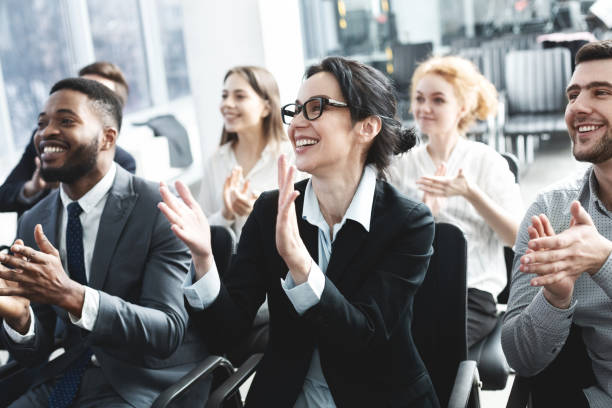 istock Business lecture. Happy executives applauding to speaker 1189158814