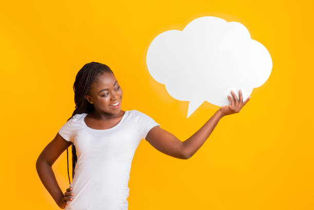 istock Interested black girl looking at communication bubble in her hand 1189159015
