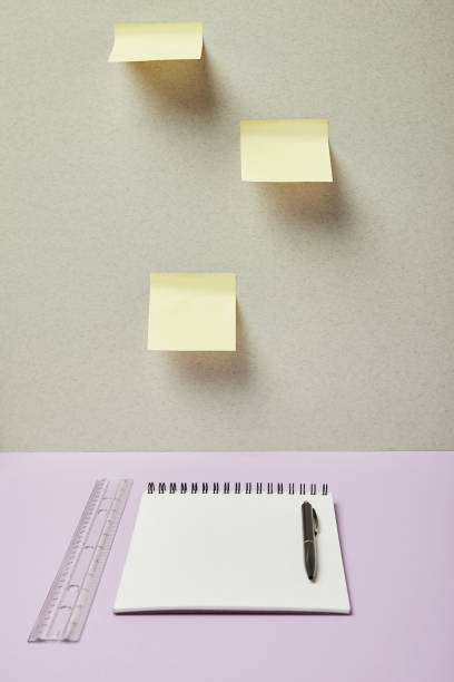 istock blank notebook near pen, ruler and sticky notes on grey and purple 1189160291