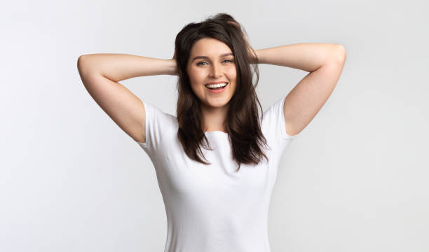 istock Positive Girl Touching Hair Standing Posing Over White Background, Studio 1189160529