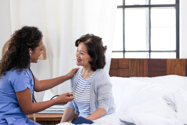 istock Nurse and female patient smile at each other during visit 1189163002