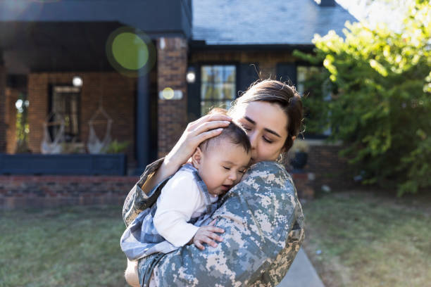 istock Military mom comforts baby daughter 1189163210