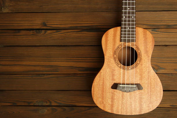 istock Ukulele musical instrument on wooden background 1189165025