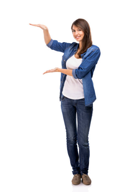 istock Beautiful woman showing something over a white background 1189165924