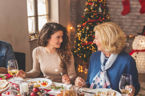 istock Mother and daughter speaking over a Christmas dinner 1189166485