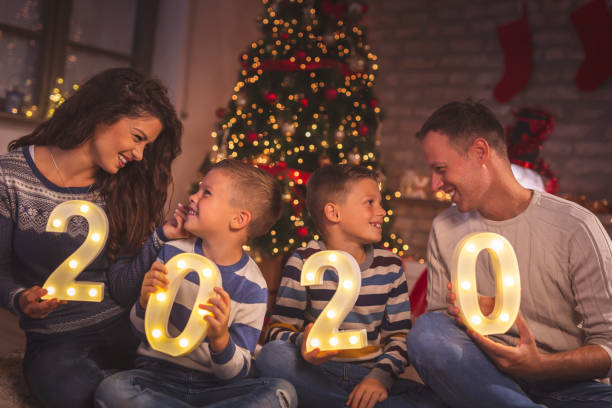 istock Parents and kids holding illuminative numbers 2020 1189166596