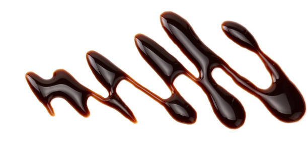 istock chocolate sauce isolated on white background. chocolate wave 1189166936