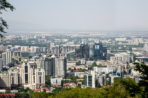Almaty panoramic view captured from the top of The Kok Tebe Hill. The Image shows the Metropole with its nearby two million citizen during a hot, sunny day.