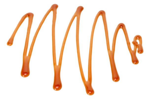 istock caramel sauce isolated on white background. caramel wave 1189167481