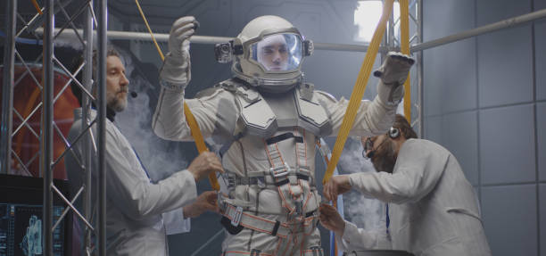 istock Scientists attaching anti-gravity bands to astronaut 1189167571
