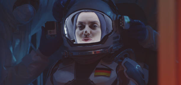 istock Scientist helping astronaut to put on spacesuit 1189167704