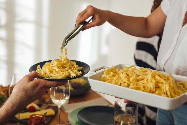 istock A Woman Serving Pasta at Home 1189167965