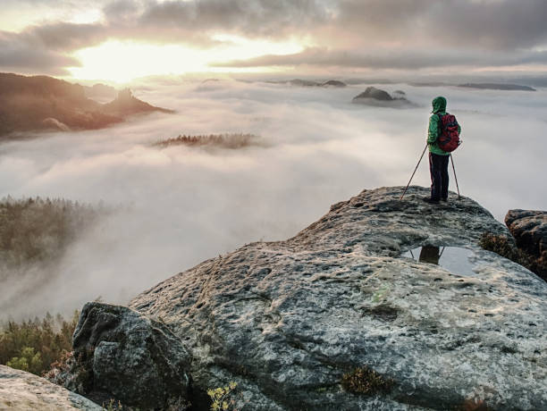 istock Hike with backpack and trekking sticks at edge. Woman visit 1189168335