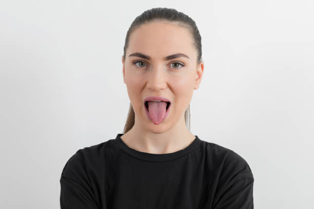 istock Young woman sticking out tongue 1189171484