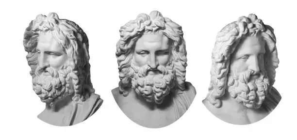 Photo of Three gypsum copy of antique statue Zeus head isolated on white background. Plaster sculpture man face with beard.